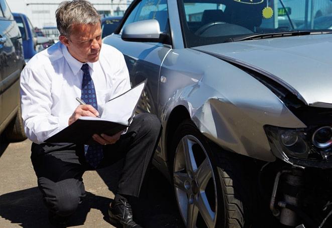 woman comparing car insurance quotes on laptop